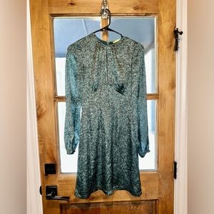 Small long sleeve green dress with slit in the center of the chest